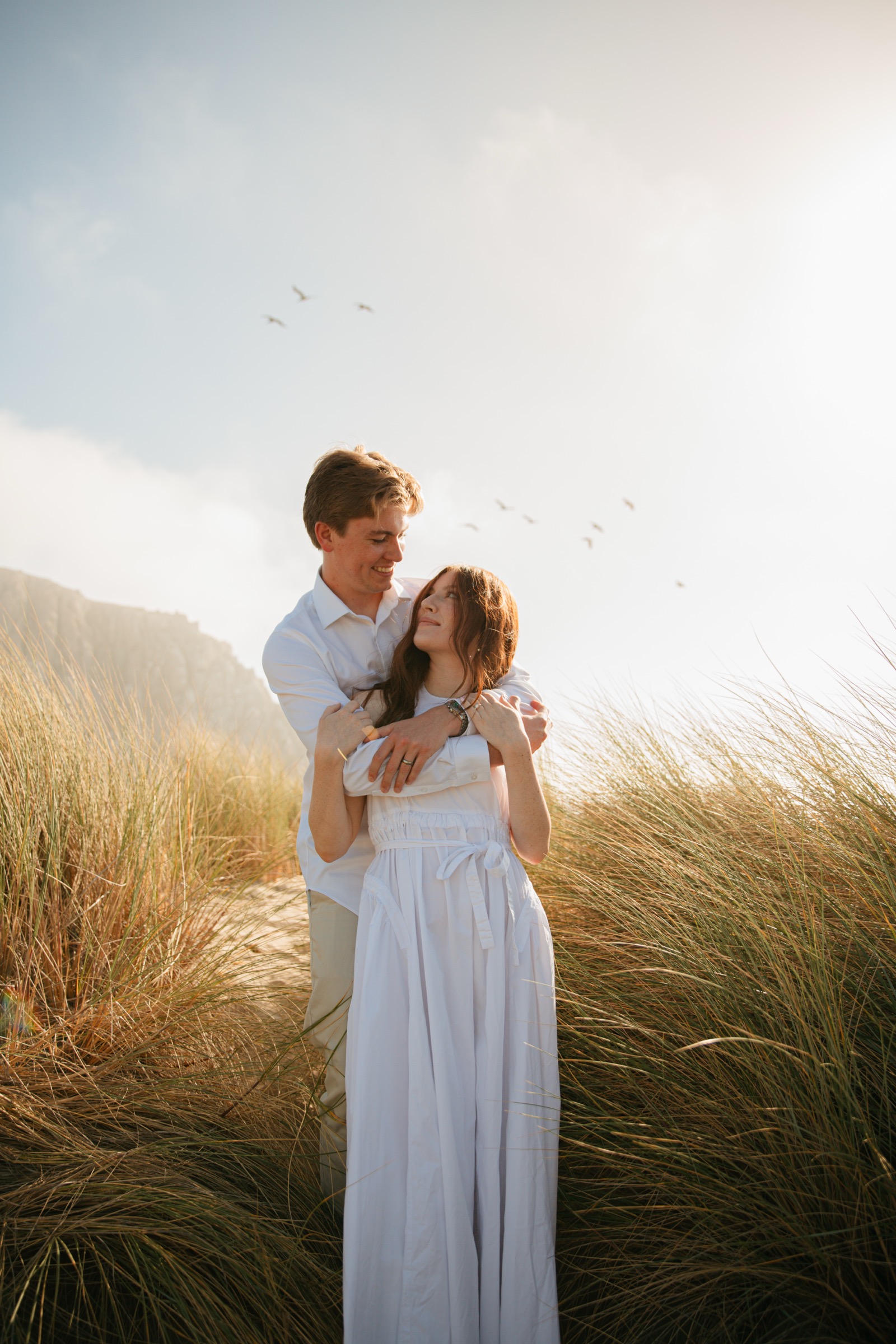 Bridget and Cole embracing in the grass
