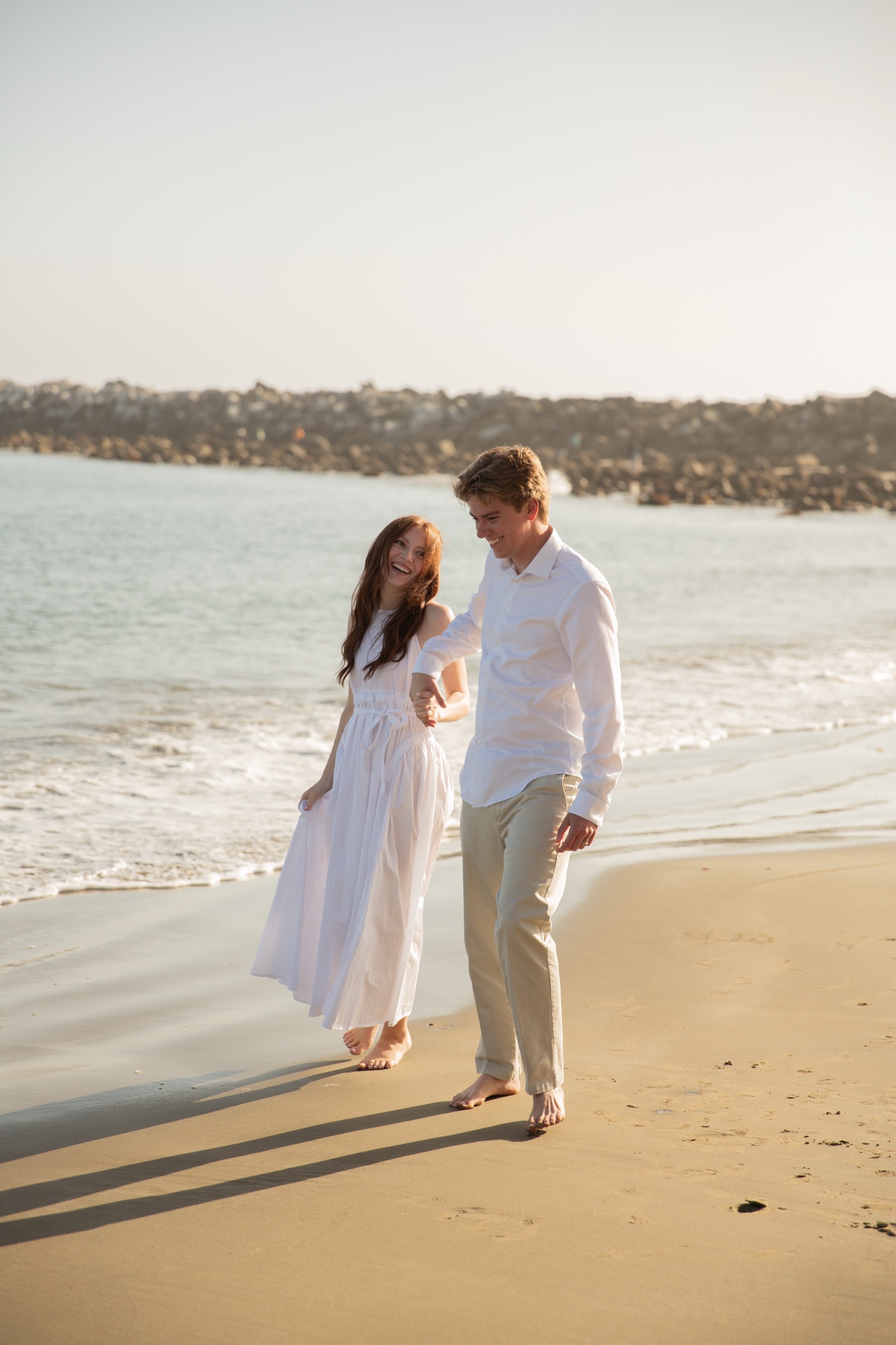 Cole and Bridget celebrating together on the beach